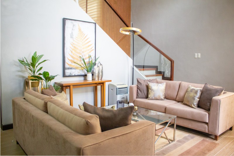 Pictured above: the main living room area with our custom-made sofas and a long-neck lamp.